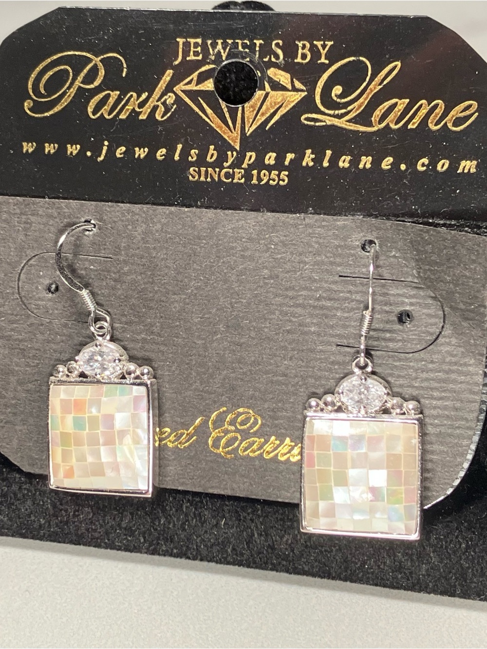 Genuine mother of pearl earrings with a 1/3 carat cubic zirconia. Mosaic design.